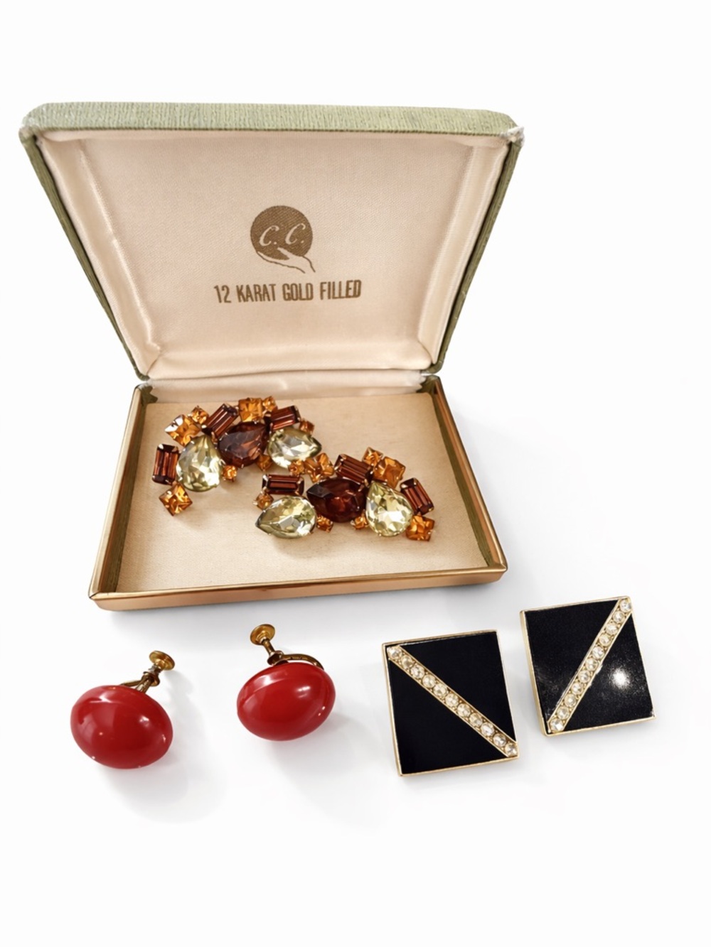 Vintage topaz color clip-on earrings plus a red & a black rhinestone pair